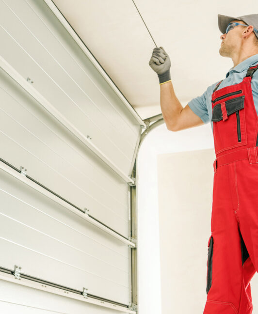 A professional inspecting a garage door to determine if it requires garage door repair in Davenport IA