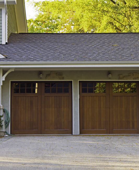 A home with two single, wood residential garage doors